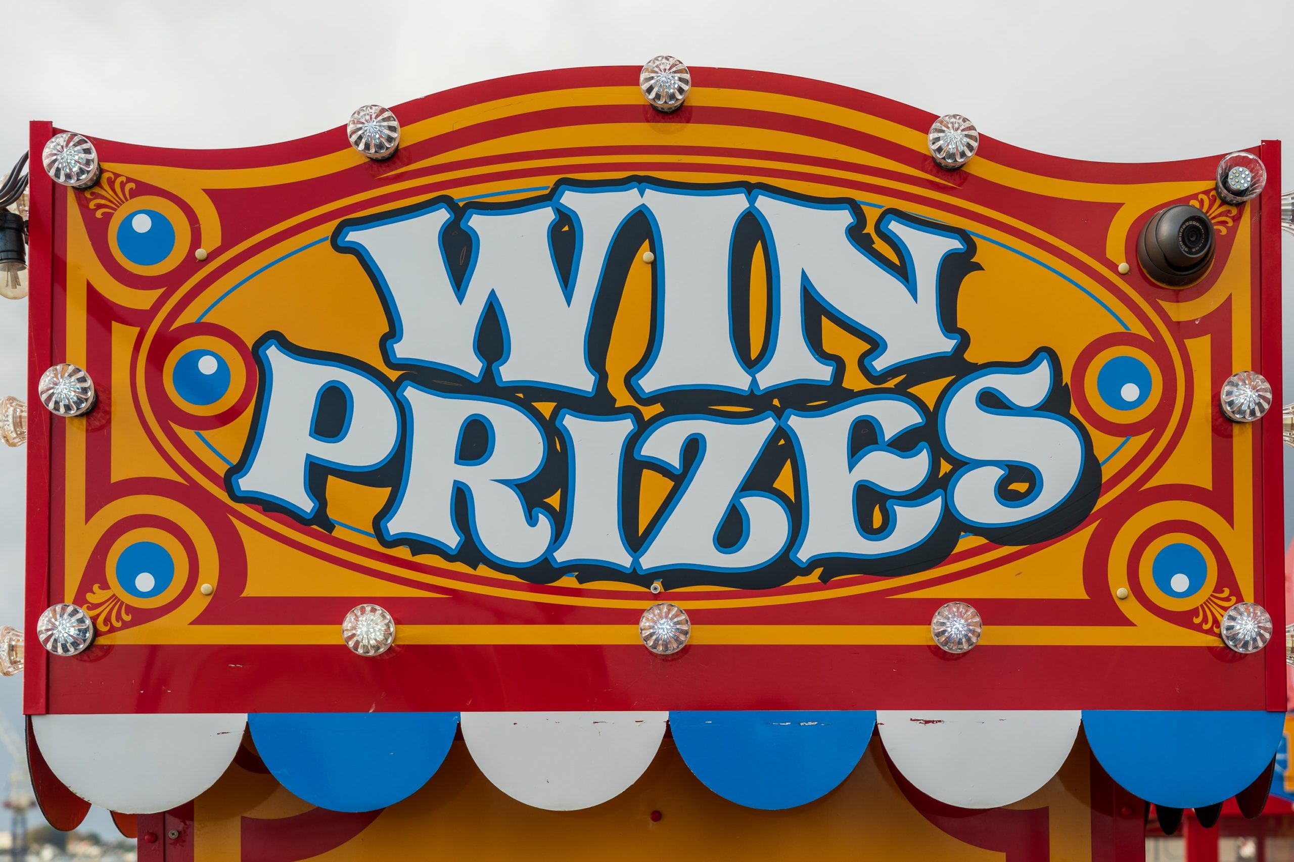 a colorful carnival sign reading 'win prizes'