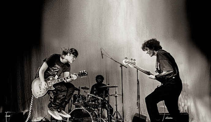 Youth band performing live on stage in black and white, capturing the energy and spirit of The Basement Door music programme